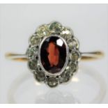 A 9ct gold ring set with garnet & paste stones siz