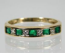 A 9ct gold emerald & diamond half eternity ring si