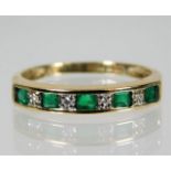 A 9ct gold emerald & diamond half eternity ring si