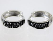 A pair of 9ct white gold earrings set with black d