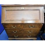 An early 20thC. oak bureau with brass fittings