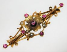 An Edwardian antique 15ct gold brooch set with ruby & pearl of organic design