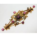 An Edwardian antique 15ct gold brooch set with ruby & pearl of organic design
