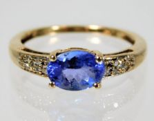 A 9ct gold tanzanite ring with diamond shoulders s