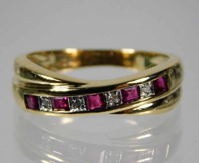 A 9ct gold diamond & ruby crossover ring size L/M