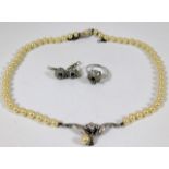 A silver mounted necklace, ring & earring set