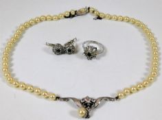 A silver mounted necklace, ring & earring set
