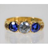 An 18ct gold ring set with blue & white stones siz