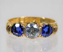 An 18ct gold ring set with blue & white stones siz