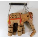 A vintage wooden elephant puppet