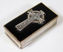 A small silver box with mounted Celtic cross