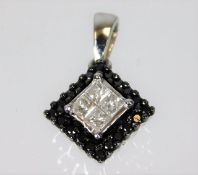 A 10ct white gold black & white diamond pendant 0.