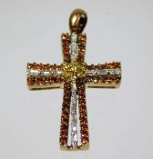 A 9ct gold cross set with white, fancy yellow & or