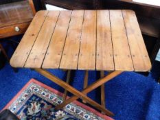 An early 20thC. campaign style table with brass fi