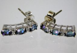 A pair of 9ct white gold drop earrings set with di