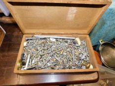 A box of various cabinet type fixings