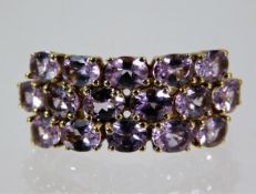 A 9ct gold ring set with three rows of pink sapphires size O 3.5g