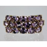 A 9ct gold ring set with three rows of pink sapphires size O 3.5g