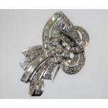 An art deco white metal dress clip set with baguet