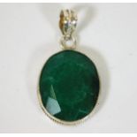 A silver mounted emerald stone pendant