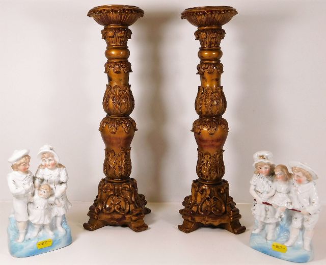 A pair of large decorative candle holders twinned