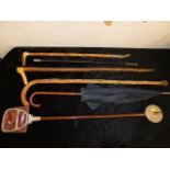 A riding crop, a shooting stick & other items