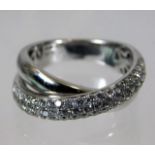 An 18ct white gold crossover ring set with approx. 1ct of diamonds size N 8.1g