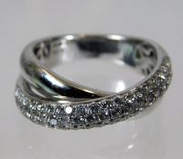 An 18ct white gold crossover ring set with approx. 1ct of diamonds size N 8.1g