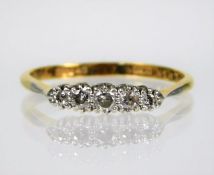 An 18ct gold ring with platinum set diamonds size