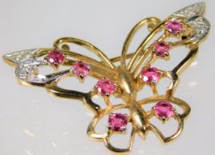 A yellow metal butterfly brooch set with diamonds