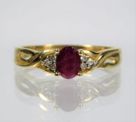 A 9ct gold ring set with ruby centre stone & small