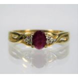 A 9ct gold ring set with ruby centre stone & small