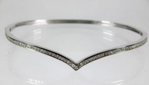 A 9ct white gold bangle set with approx. 0.61ct of