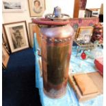 A vintage copper fire extinguisher