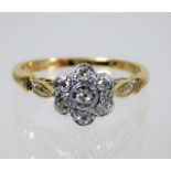 An antique 18ct gold diamond daisy ring set in pla