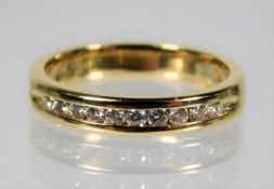 An 18ct gold half eternity ring set with diamond s