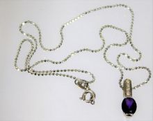 A white metal pendant set with diamonds & amethyst