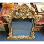 A large decorative overmantle mirror