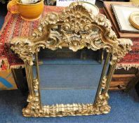 A large decorative overmantle mirror