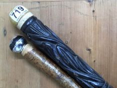 One carved ebonised cane twinned with one other