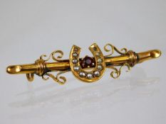 A 9ct gold lucky horseshoe brooch set with seed pe