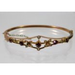 A yellow metal antique bangle set with garnet & pe