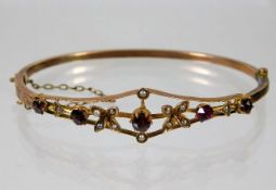 A yellow metal antique bangle set with garnet & pe