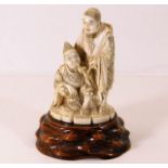 A 19thC. Japanese ivory carving including stand, f