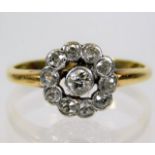 A yellow metal, tests as 18ct gold, diamond set daisy ring, size K 2.4g
