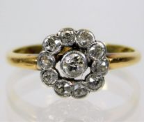 A yellow metal, tests as 18ct gold, diamond set daisy ring, size K 2.4g