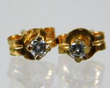 A pair of 9ct gold stud earrings set with diamonds