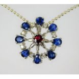 A 9ct white gold pendant set with sapphire, garnet