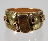 A 14ct two colour gold ring with organic decor & g