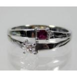 A 14ct white gold ring set with ruby & 0.25ct diam